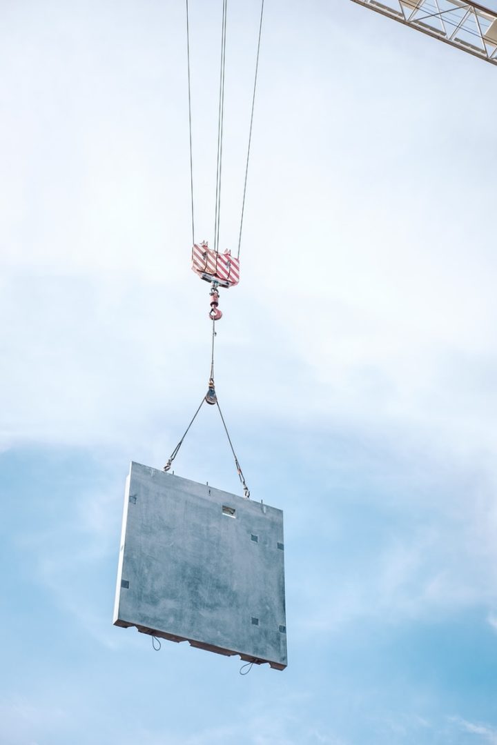 Large piece of concrete being lifted by a crane